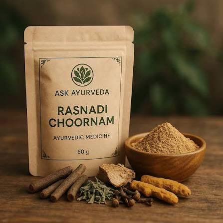 A packet of Rasnadi choornam herbal powder with a wooden bowl of the powder and dried herbs